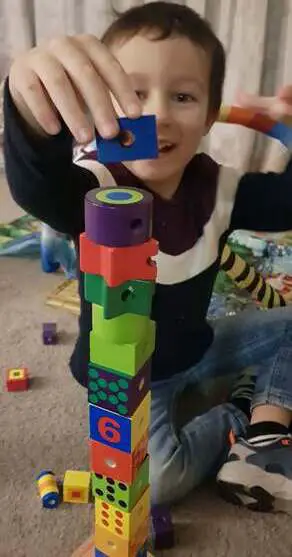 building a tall tower using the wooden lacing blocks